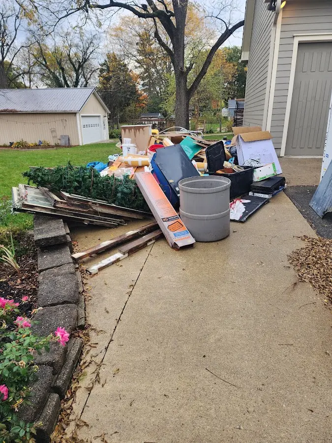 Dumpster being loaded with debris for Estate Cleanout Dumpster Rental in Blooming Grove